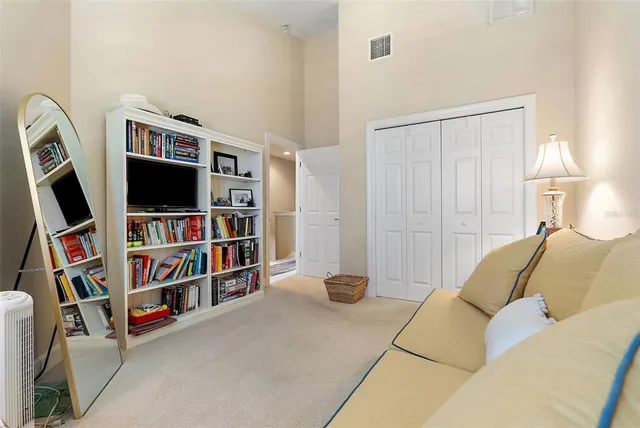 a living room with a couch and a book shelf