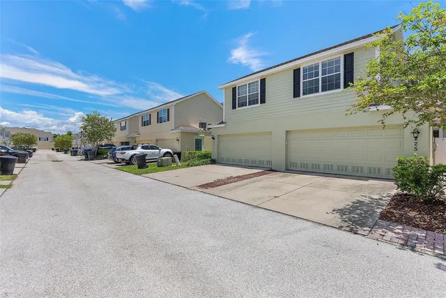 a front view of a house with a yard and a garage