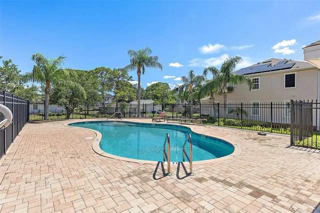 a swimming pool with outdoor seating and yard