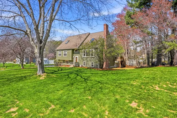 a view of a house with a backyard