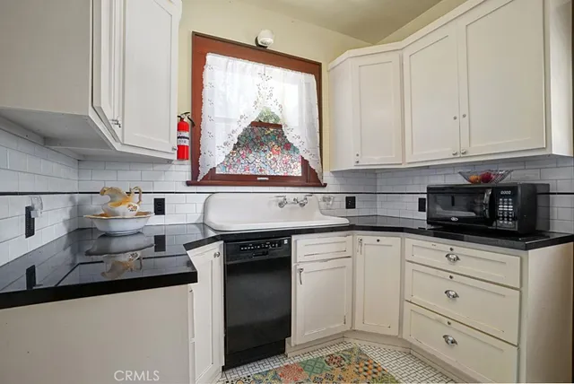 a kitchen with stainless steel appliances granite countertop a sink and a stove