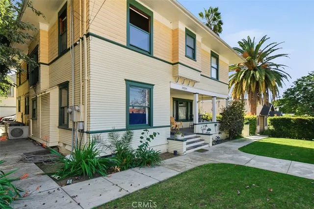 a front view of a house with garden and patio