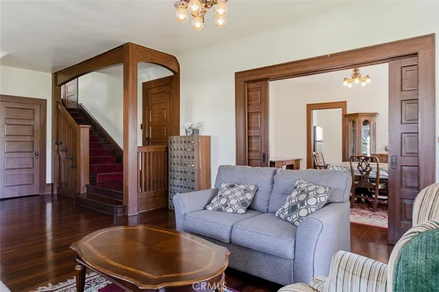 a living room with furniture and a chandelier