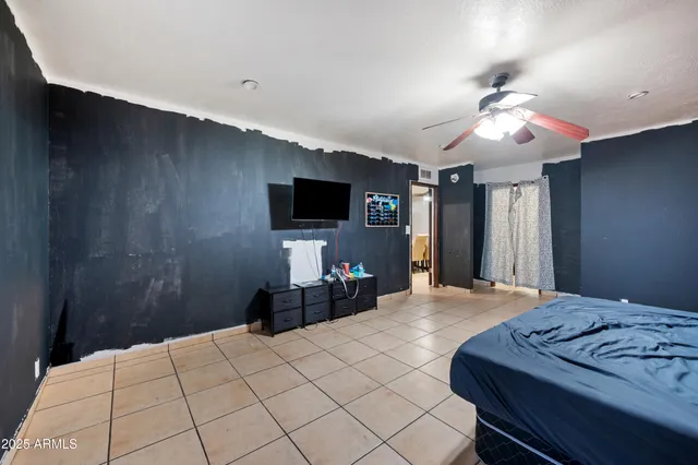 a bedroom with a bed and a flat screen tv