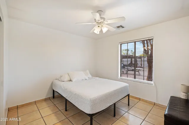 a bedroom with a bed and a window