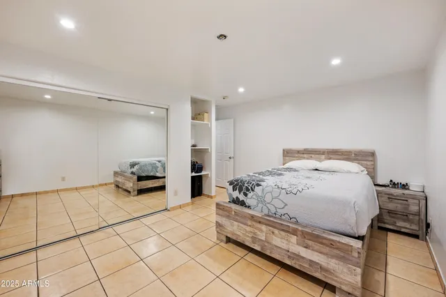 a spacious bedroom with a bed and a cabinets