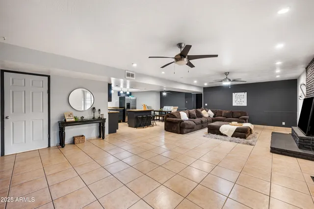 a living room with furniture and a chandelier