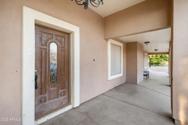 a living room with furniture a clock and a ceiling fan