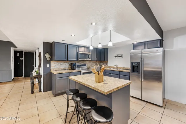 a kitchen with a refrigerator a sink and a stove
