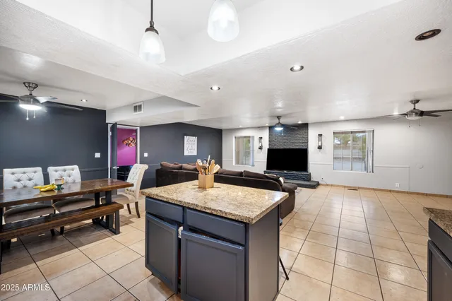 a kitchen with stainless steel appliances kitchen island granite countertop a sink and cabinets