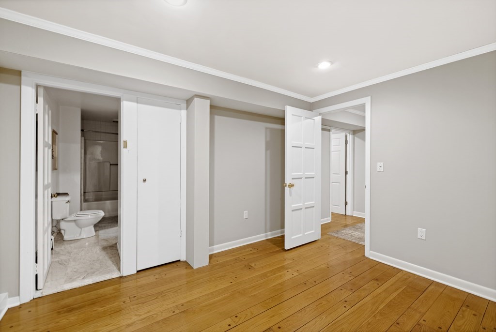 77 Hallwood Road Brookline, MA 02467 - Photo 39 of 42 a view of a room with wooden floor and a bathroom