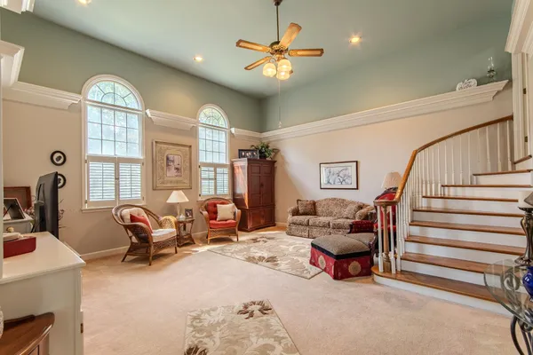 a living room with furniture and a chandelier