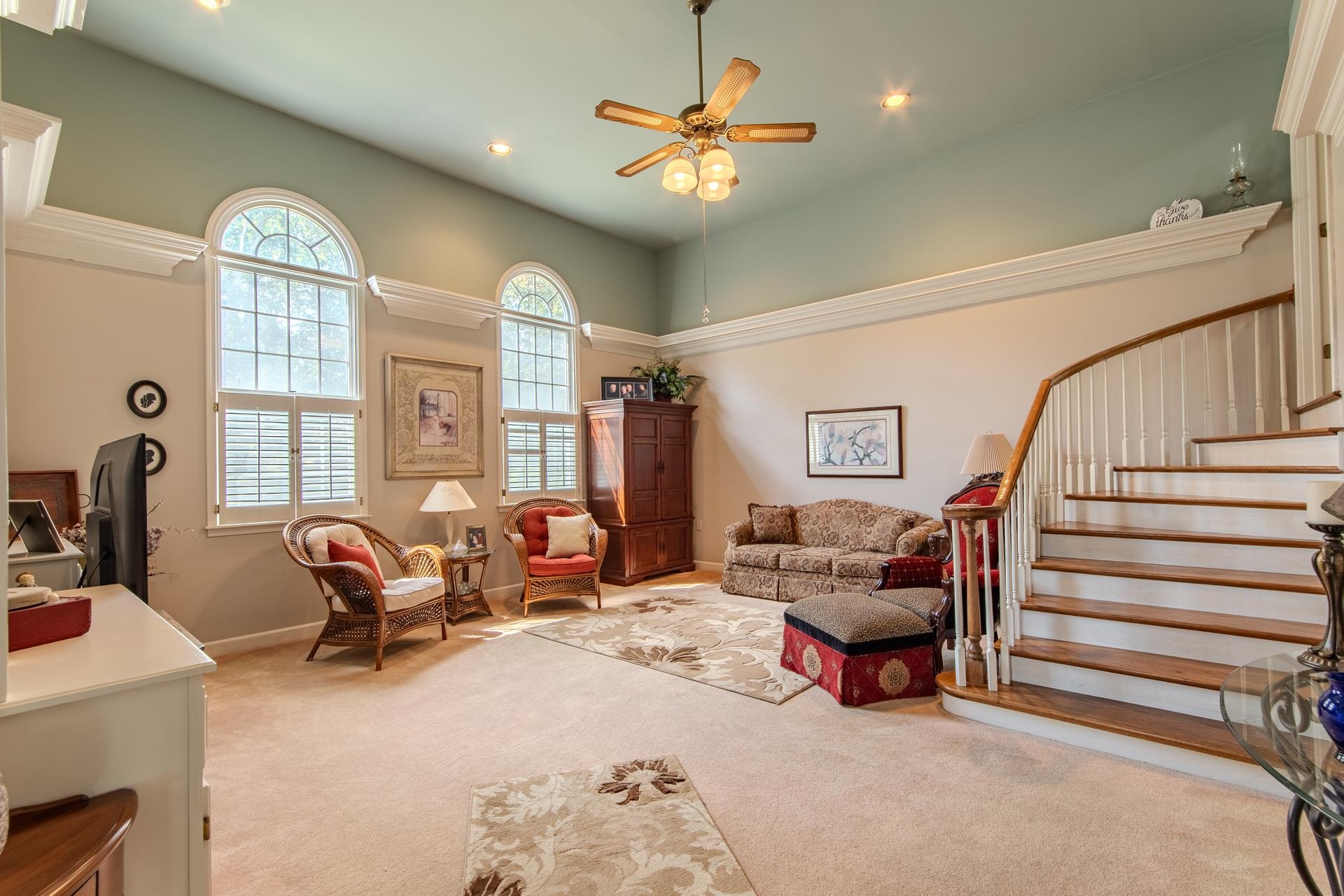 a living room with furniture and a chandelier