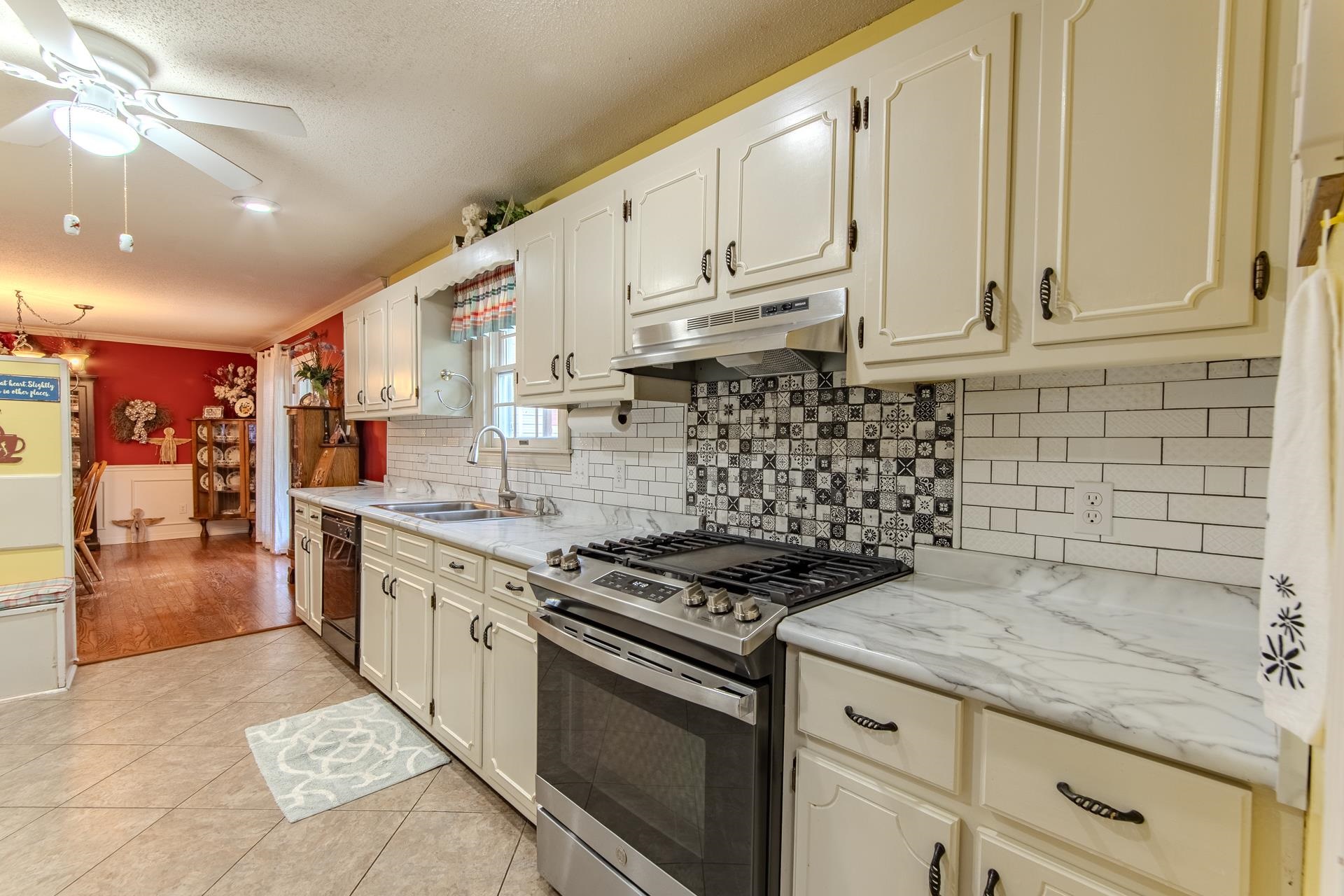 313 Country Club Lane Selmer, TN 38375 - Photo 11 of 36 a kitchen with granite countertop a stove sink and cabinets