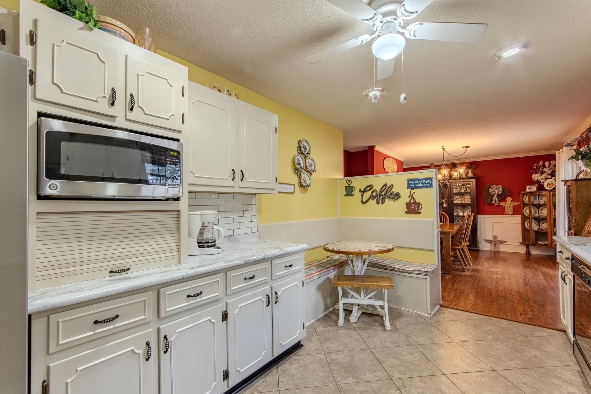 313 Country Club Lane Selmer, TN 38375 - Photo 12 of 36 a kitchen with stainless steel appliances kitchen island granite countertop a sink and cabinets