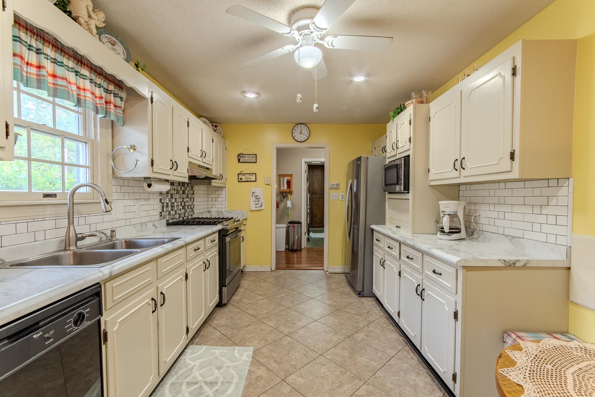 313 Country Club Lane Selmer, TN 38375 - Photo 14 of 36 a large kitchen with stainless steel appliances granite countertop a sink and cabinets