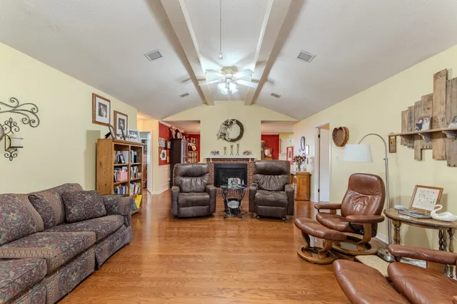a living room with fireplace furniture and a chandelier