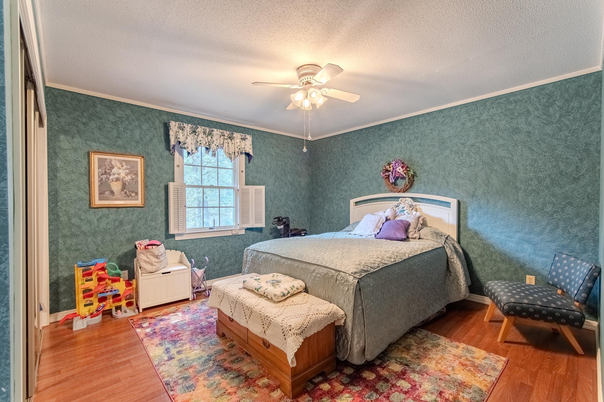 313 Country Club Lane Selmer, TN 38375 - Photo 23 of 36 a bedroom with a bed and wooden floor
