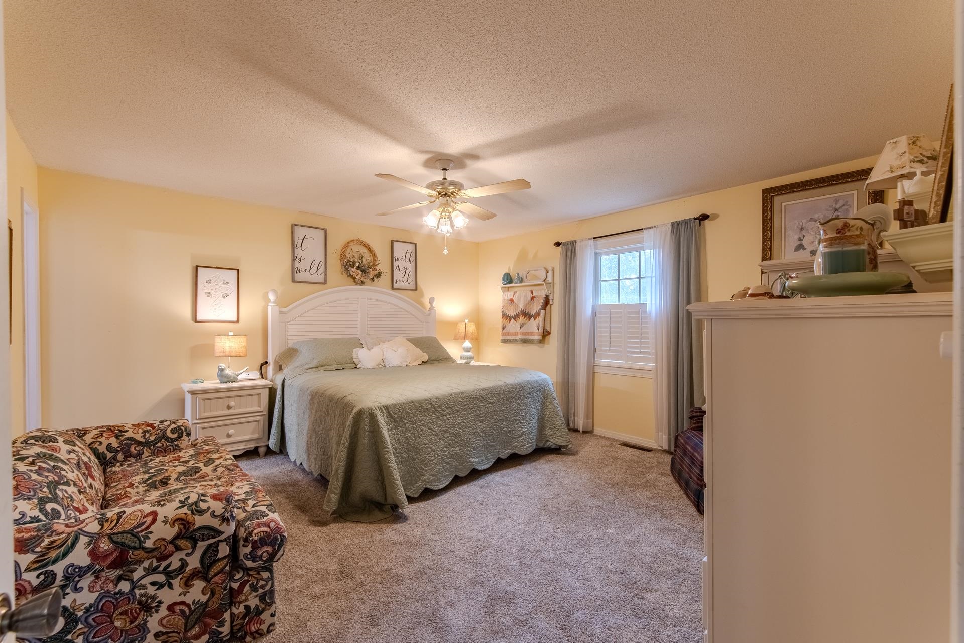313 Country Club Lane Selmer, TN 38375 - Photo 24 of 36 a spacious bedroom with a bed and a chandelier