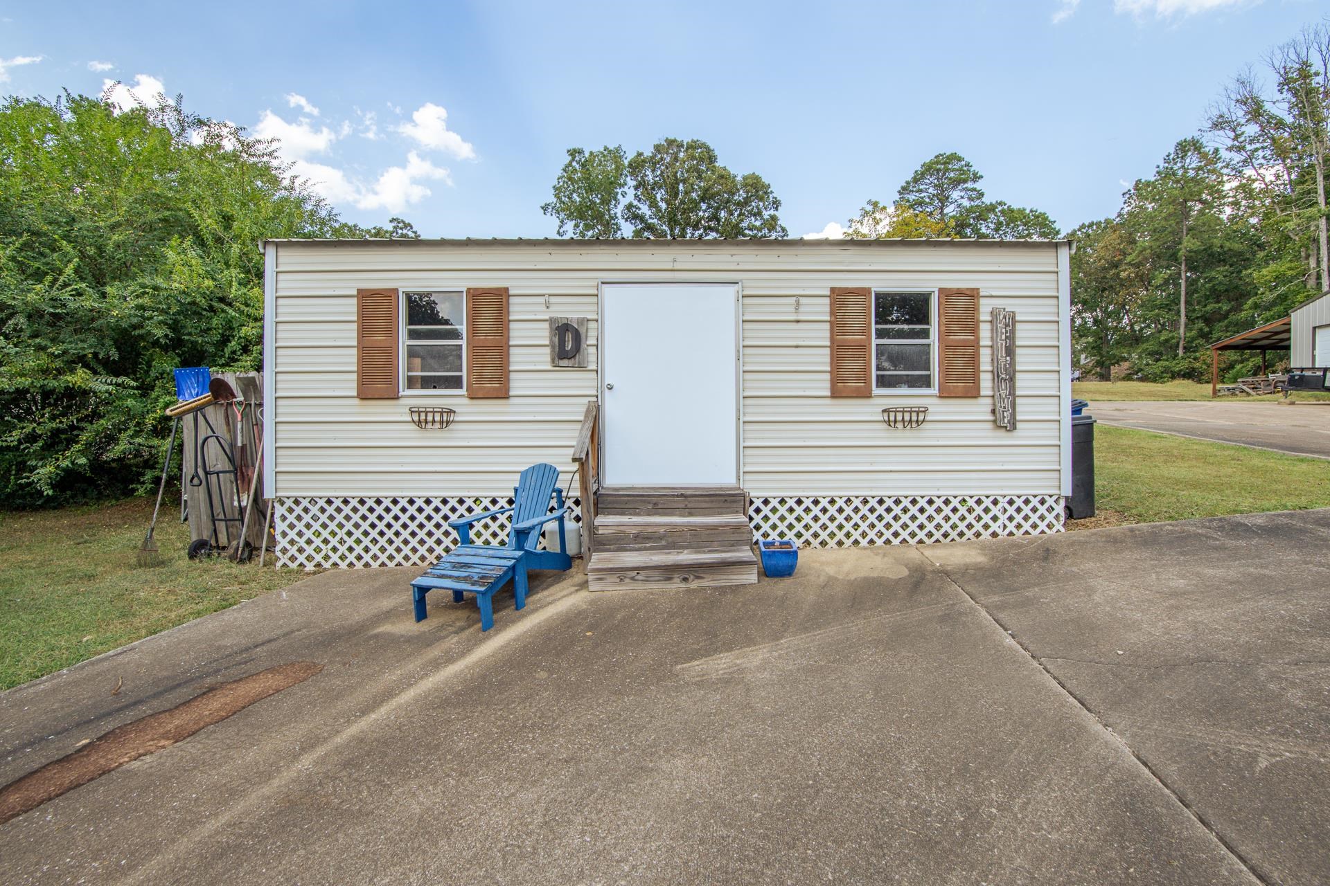 313 Country Club Lane Selmer, TN 38375 - Photo 28 of 36 a view of a house with a yard and garage