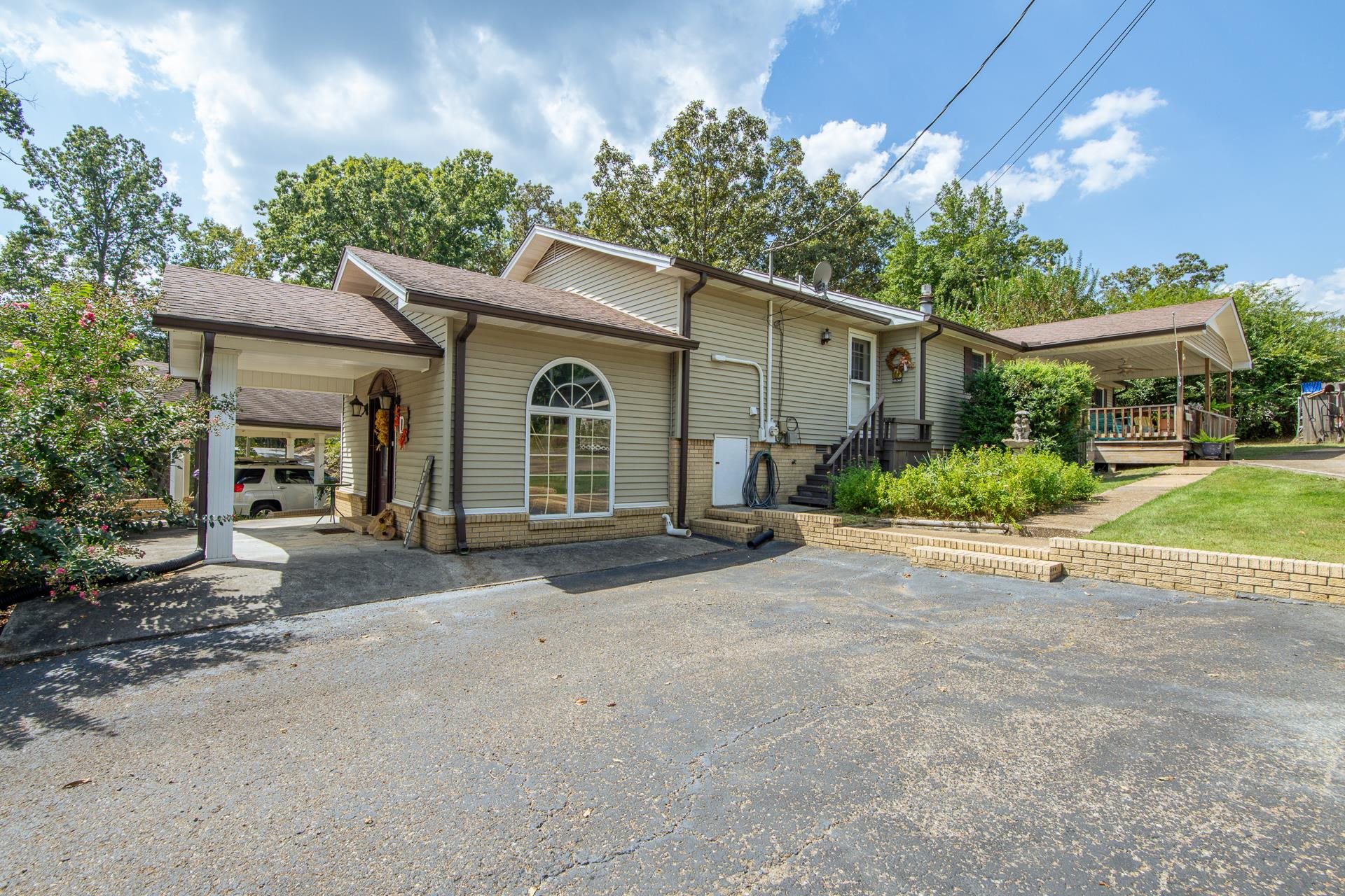 313 Country Club Lane Selmer, TN 38375 - Photo 33 of 36 a view of a house with backyard and a garden