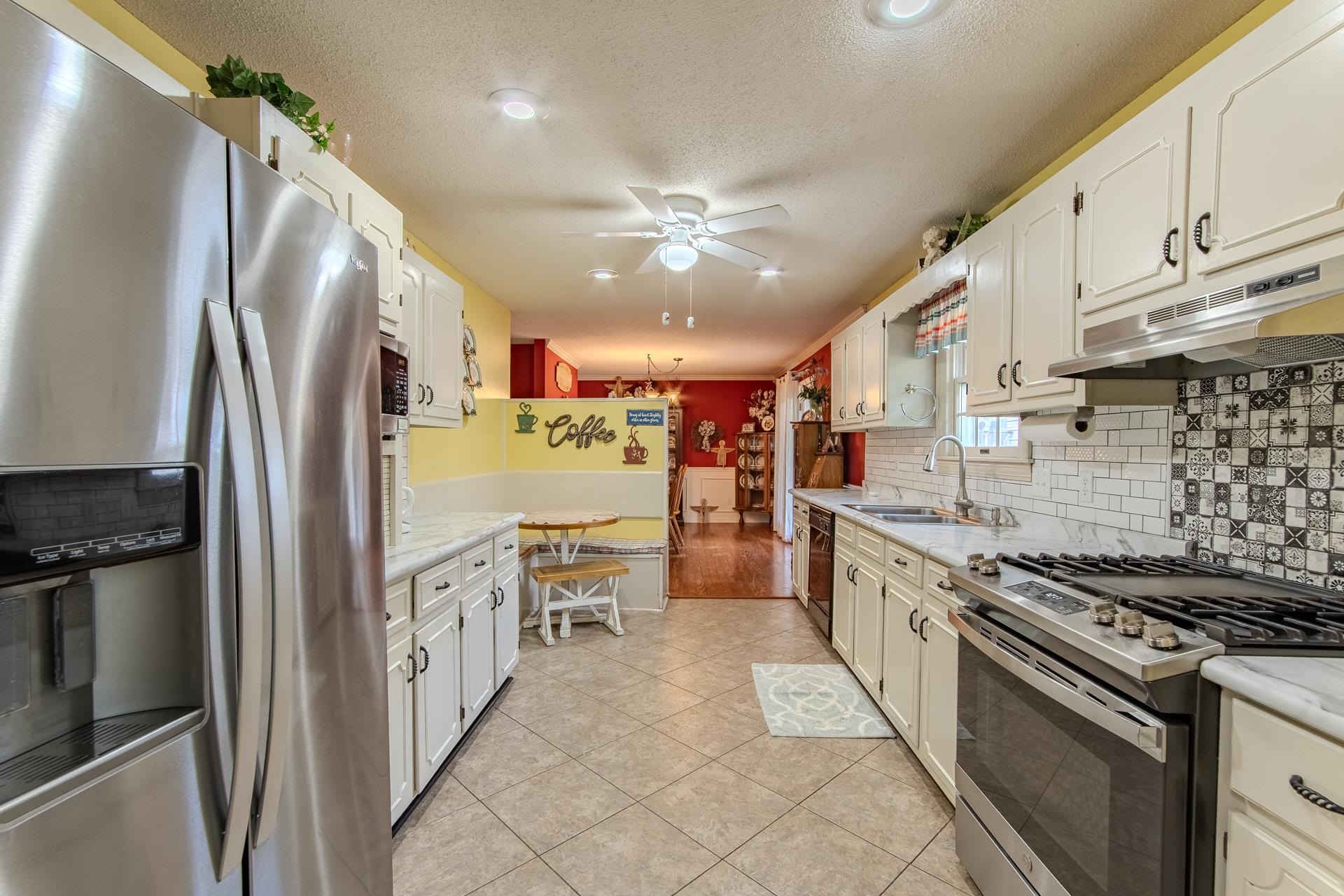 313 Country Club Lane Selmer, TN 38375 - Photo 10 of 36 a kitchen with stainless steel appliances granite countertop a stove a refrigerator and a refrigerator