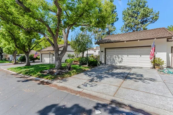 a front view of a house with a yard and a garage