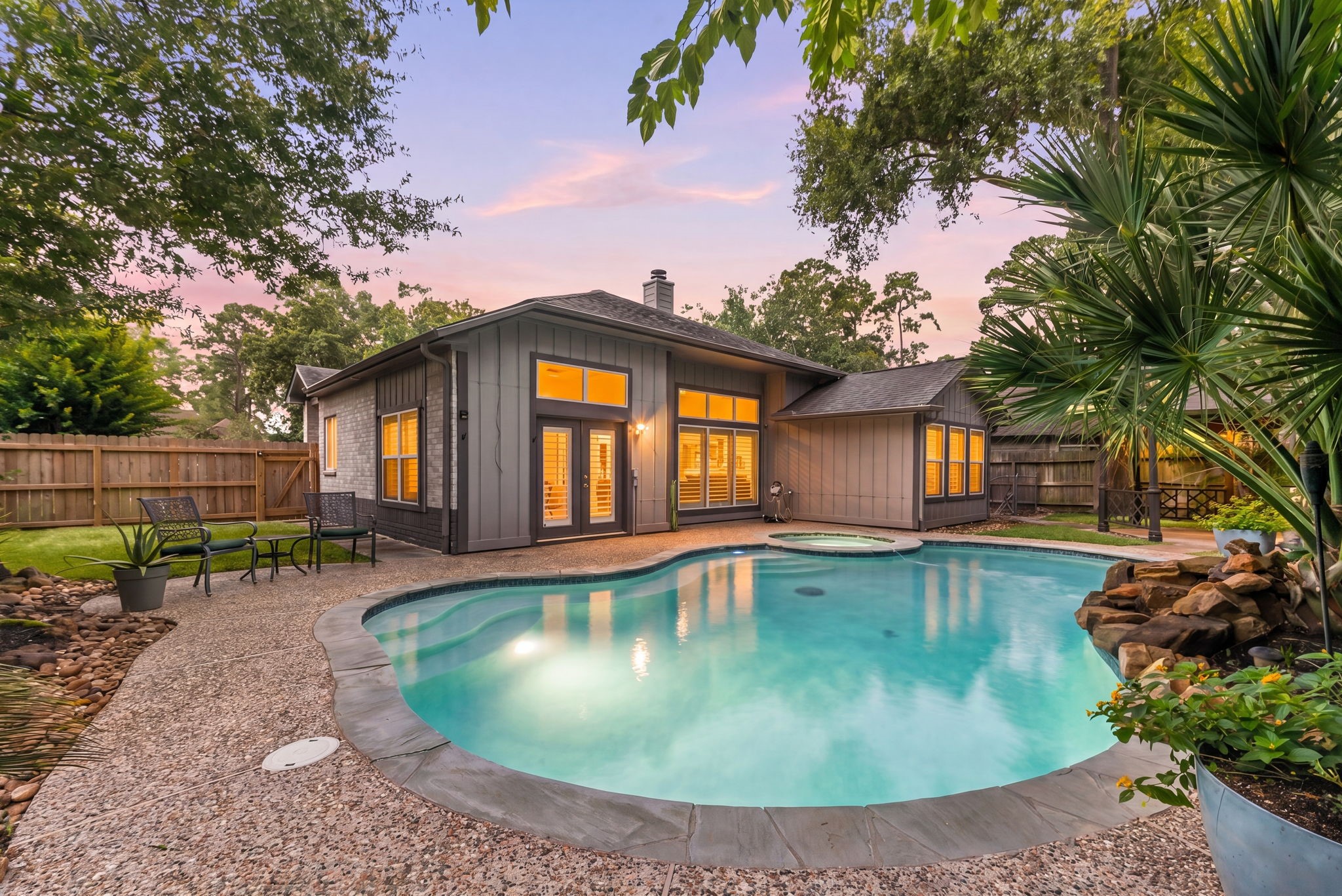 1915 Mercoal Drive Spring, TX 77386 - Photo 2 of 50 Private backyard oasis featuring a sparkling in-ground pool surrounded by mature landscaping.