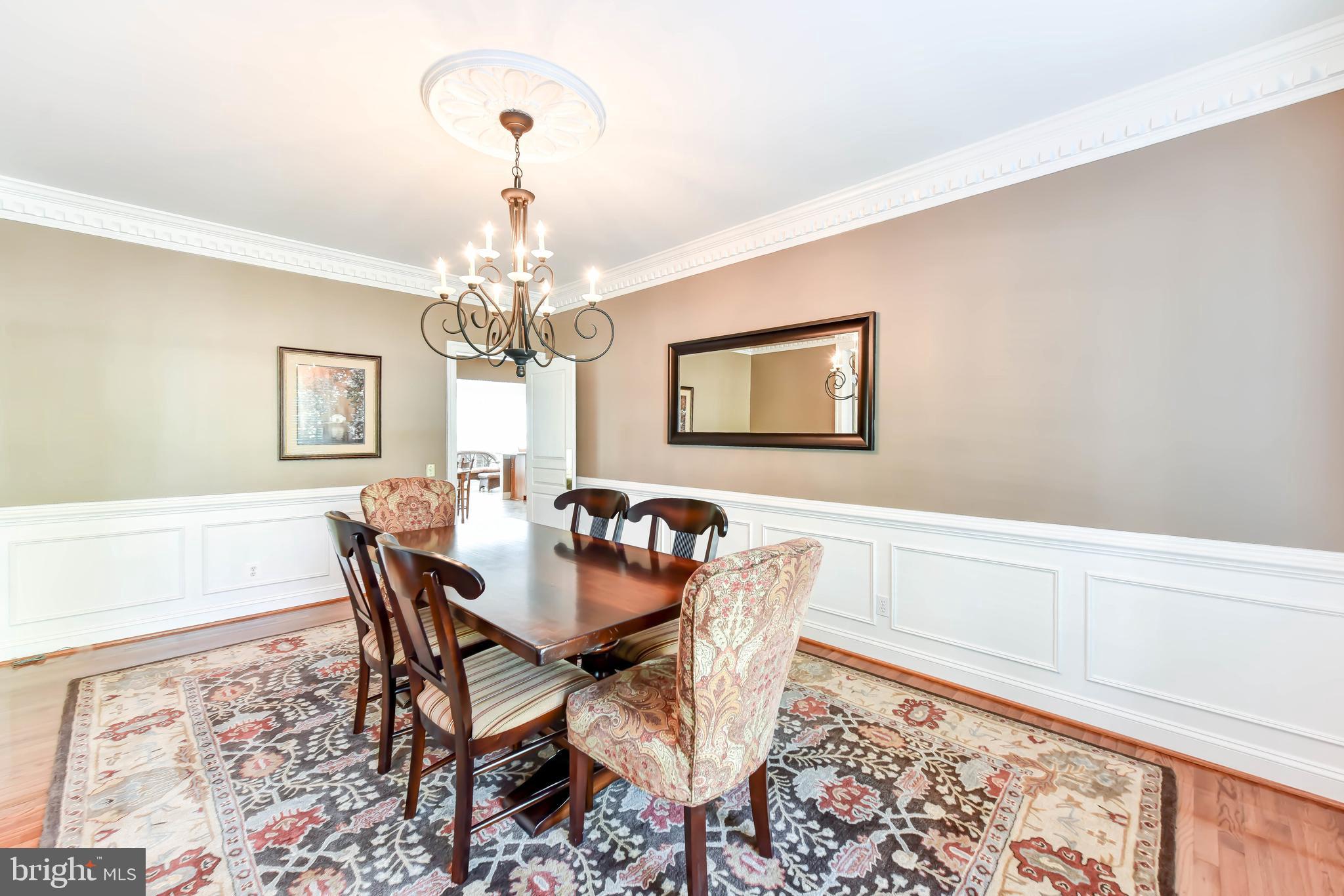 8244 Native Violet Drive Lorton, VA 22079 - Photo 14 of 68 a dining room with chandelier and wooden floor