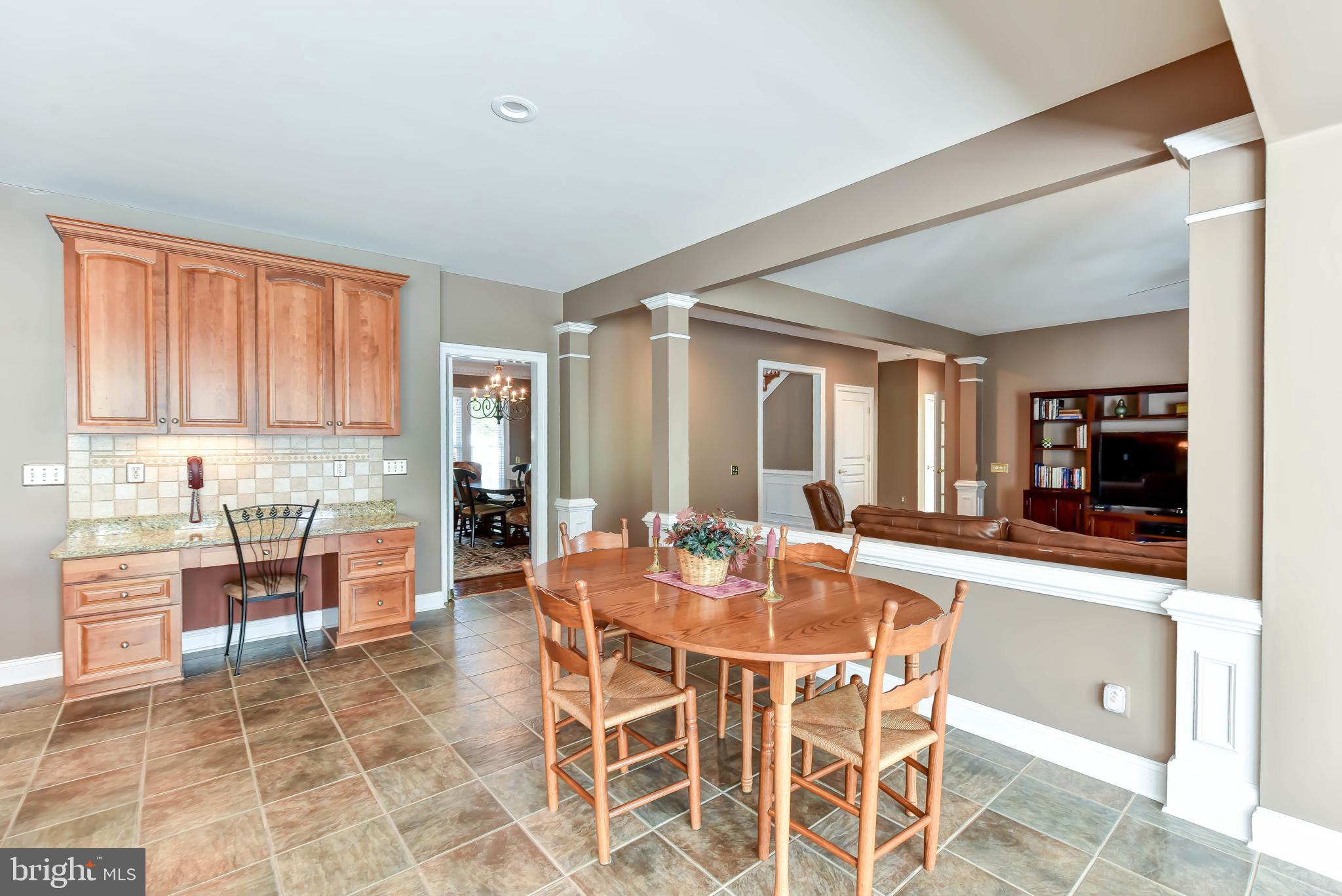 8244 Native Violet Drive Lorton, VA 22079 - Photo 15 of 68 a dining hall with stainless steel appliances granite countertop a table and chairs