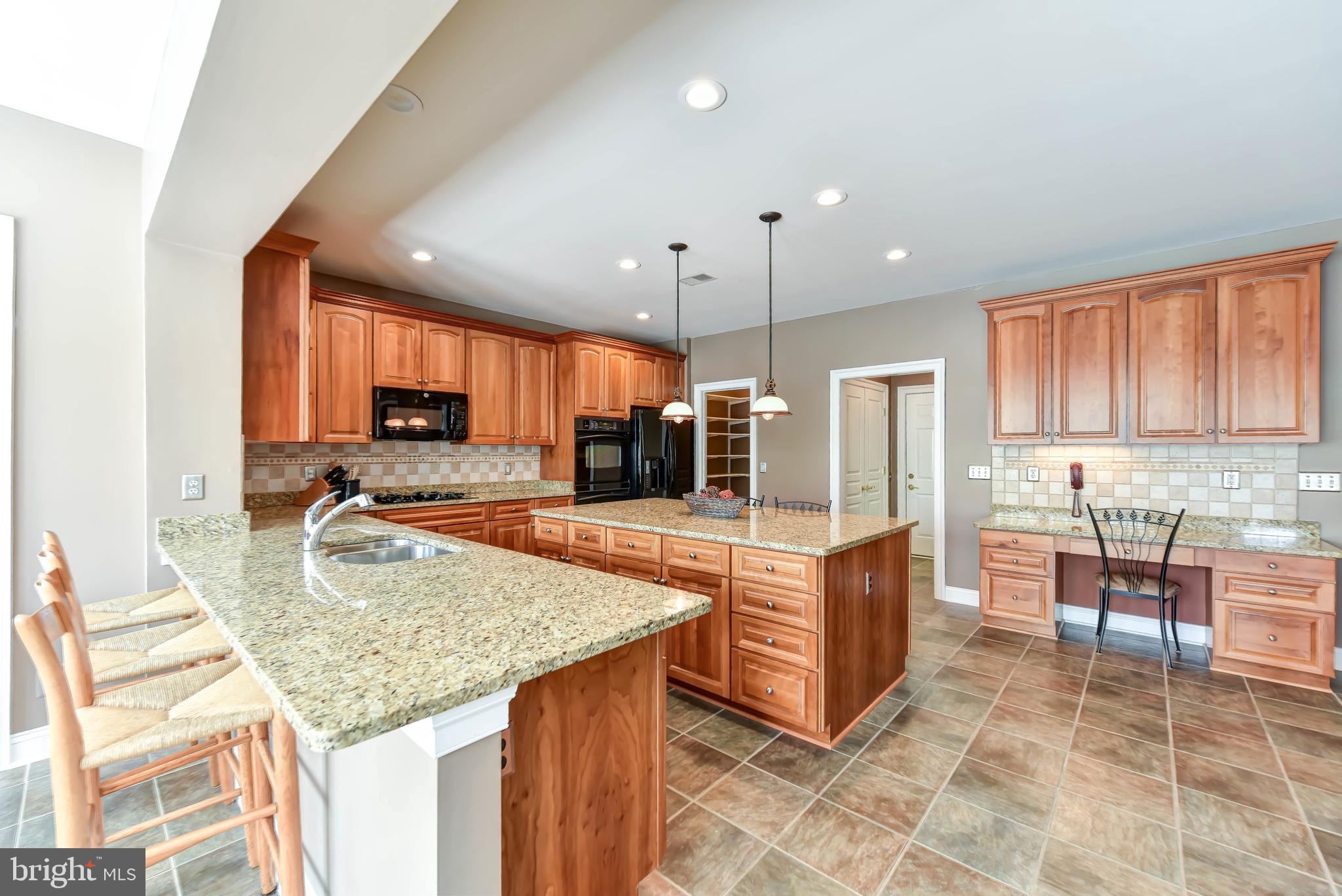 8244 Native Violet Drive Lorton, VA 22079 - Photo 17 of 68 a kitchen with stainless steel appliances granite countertop a stove and a sink