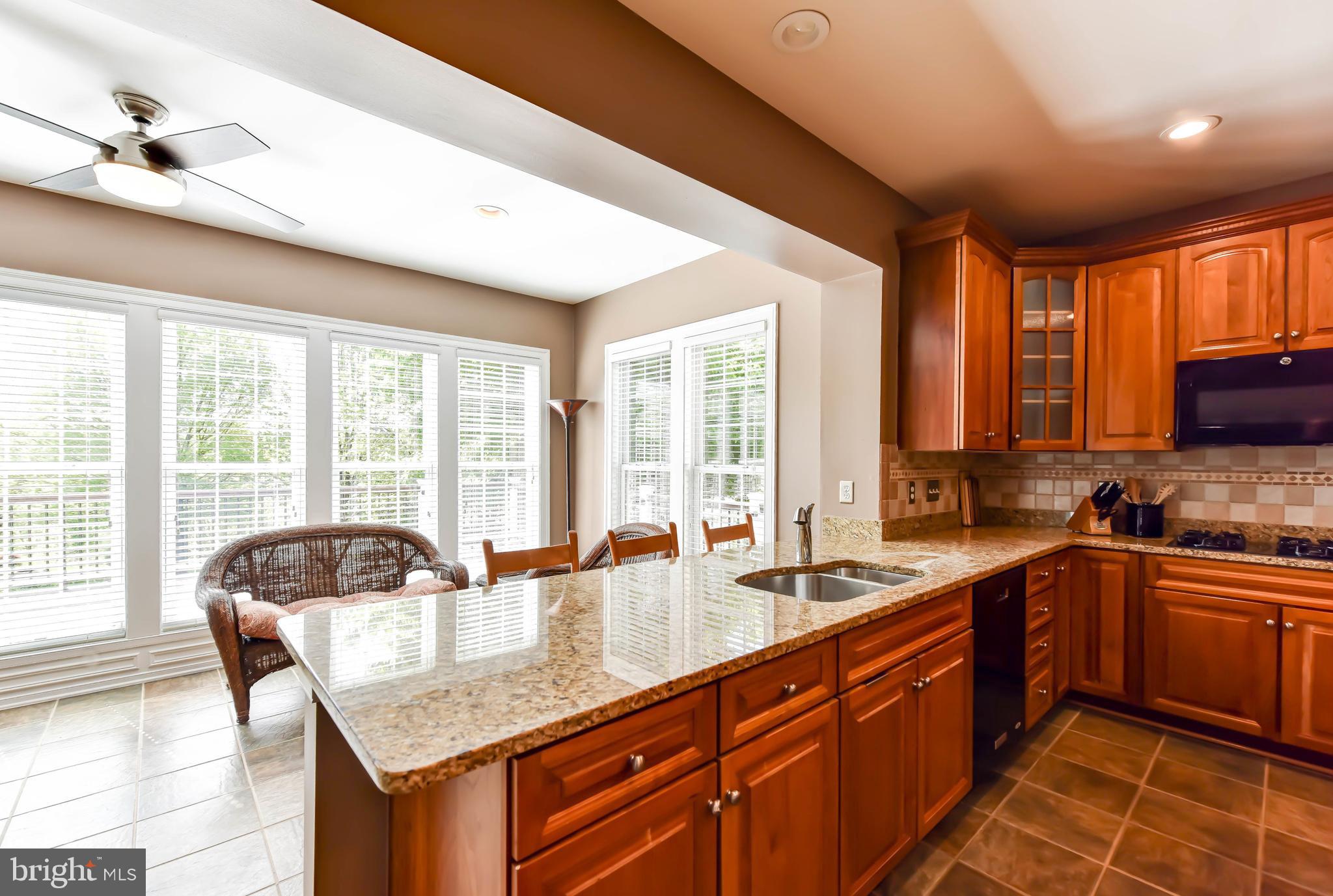 8244 Native Violet Drive Lorton, VA 22079 - Photo 18 of 68 a kitchen with granite countertop a sink and a stove