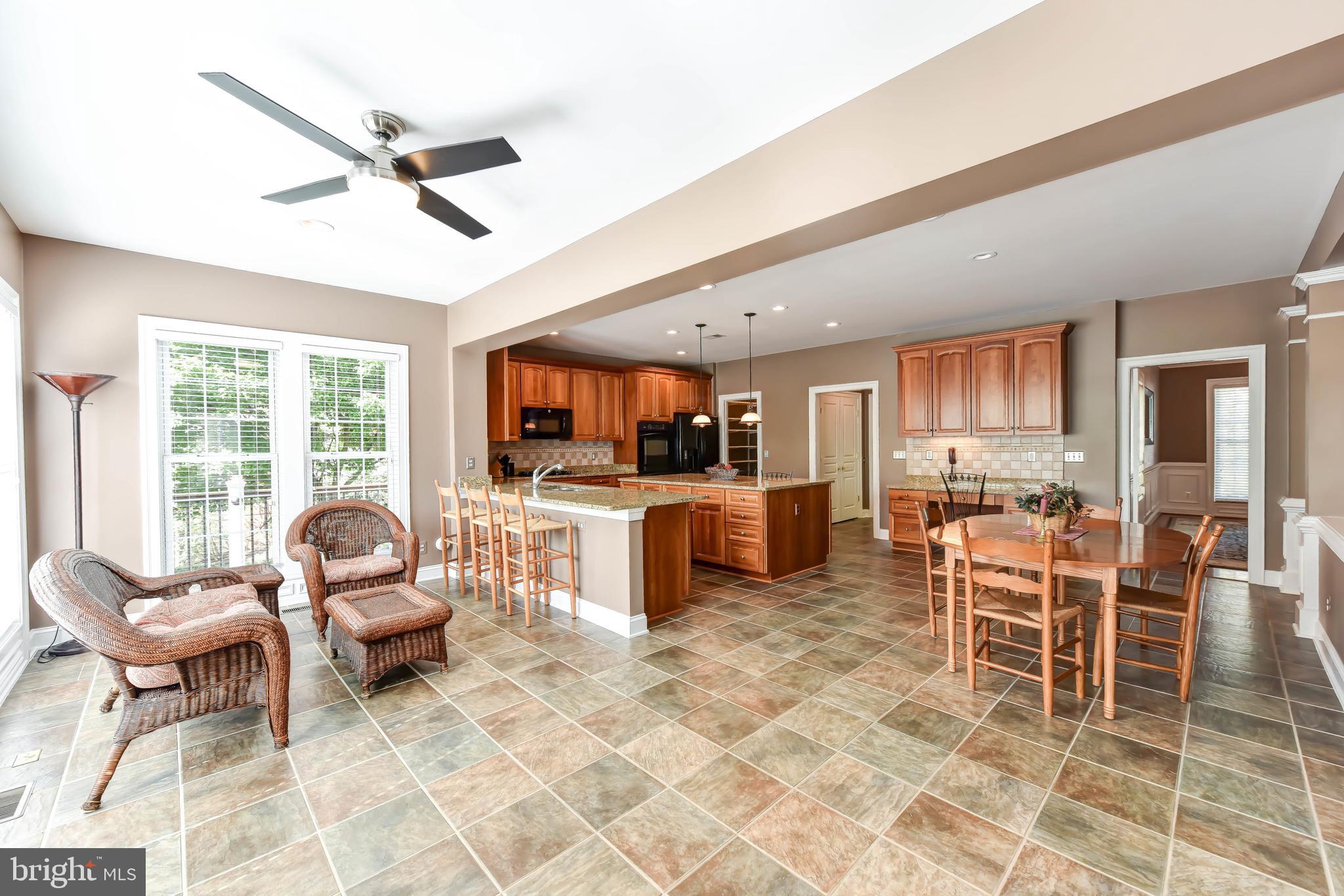 8244 Native Violet Drive Lorton, VA 22079 - Photo 23 of 68 a living room with furniture a dining table and a flat screen tv