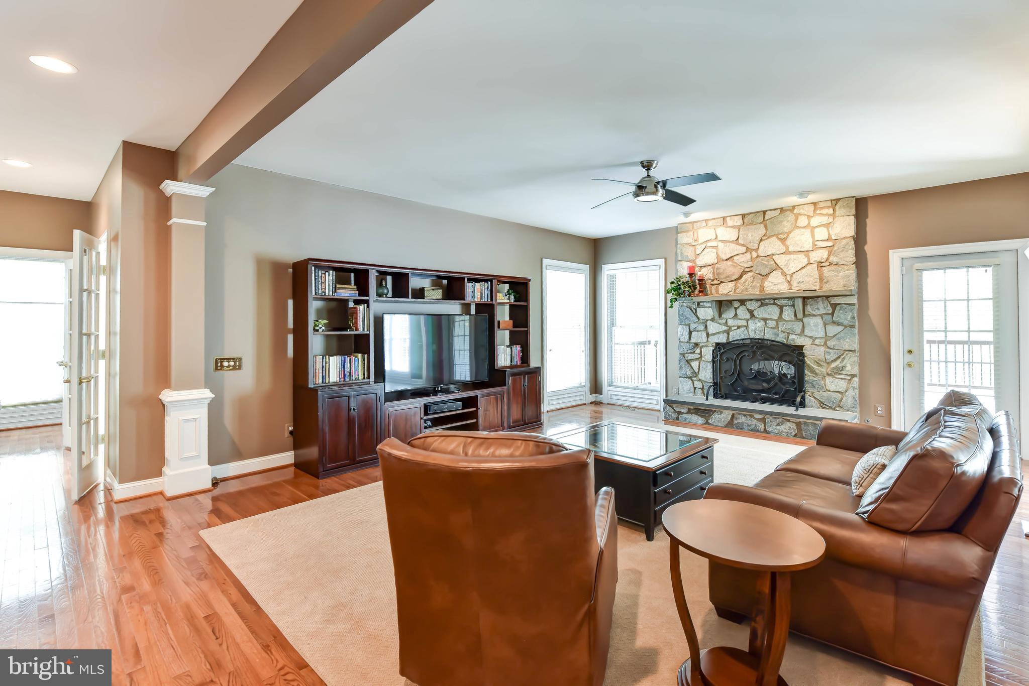 8244 Native Violet Drive Lorton, VA 22079 - Photo 25 of 68 a living room with furniture a flat screen tv and a large window