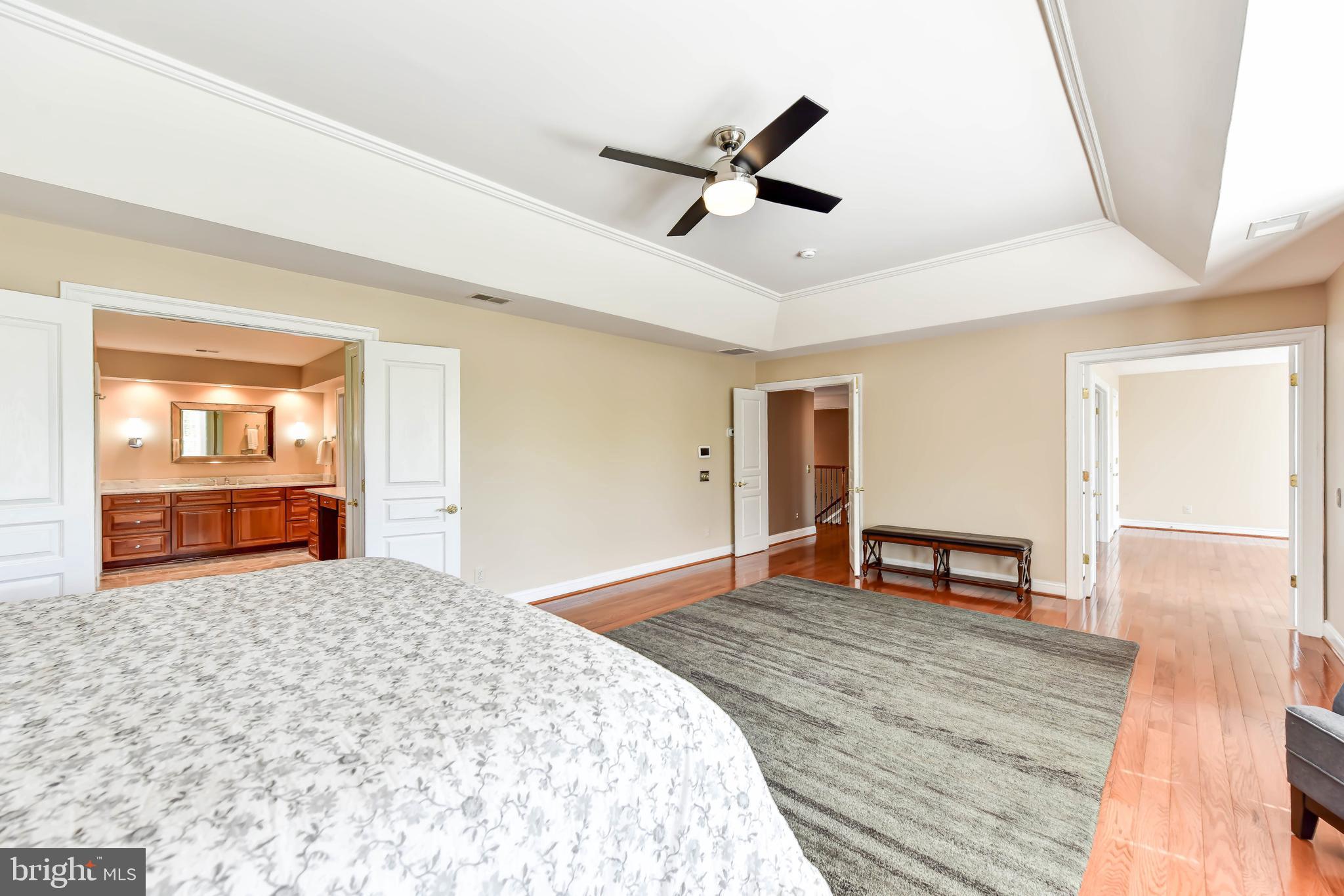 8244 Native Violet Drive Lorton, VA 22079 - Photo 37 of 68 a bedroom with a bed and dresser with wooden floor