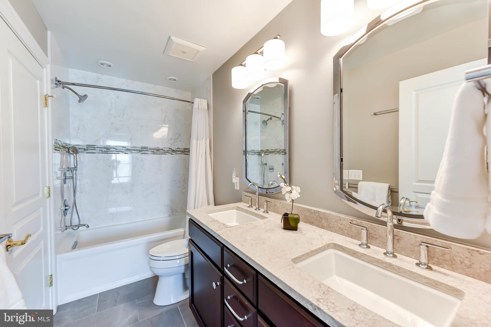 8244 Native Violet Drive Lorton, VA 22079 - Photo 42 of 68 a bathroom with a bathtub shower sink vanity mirror and toilet