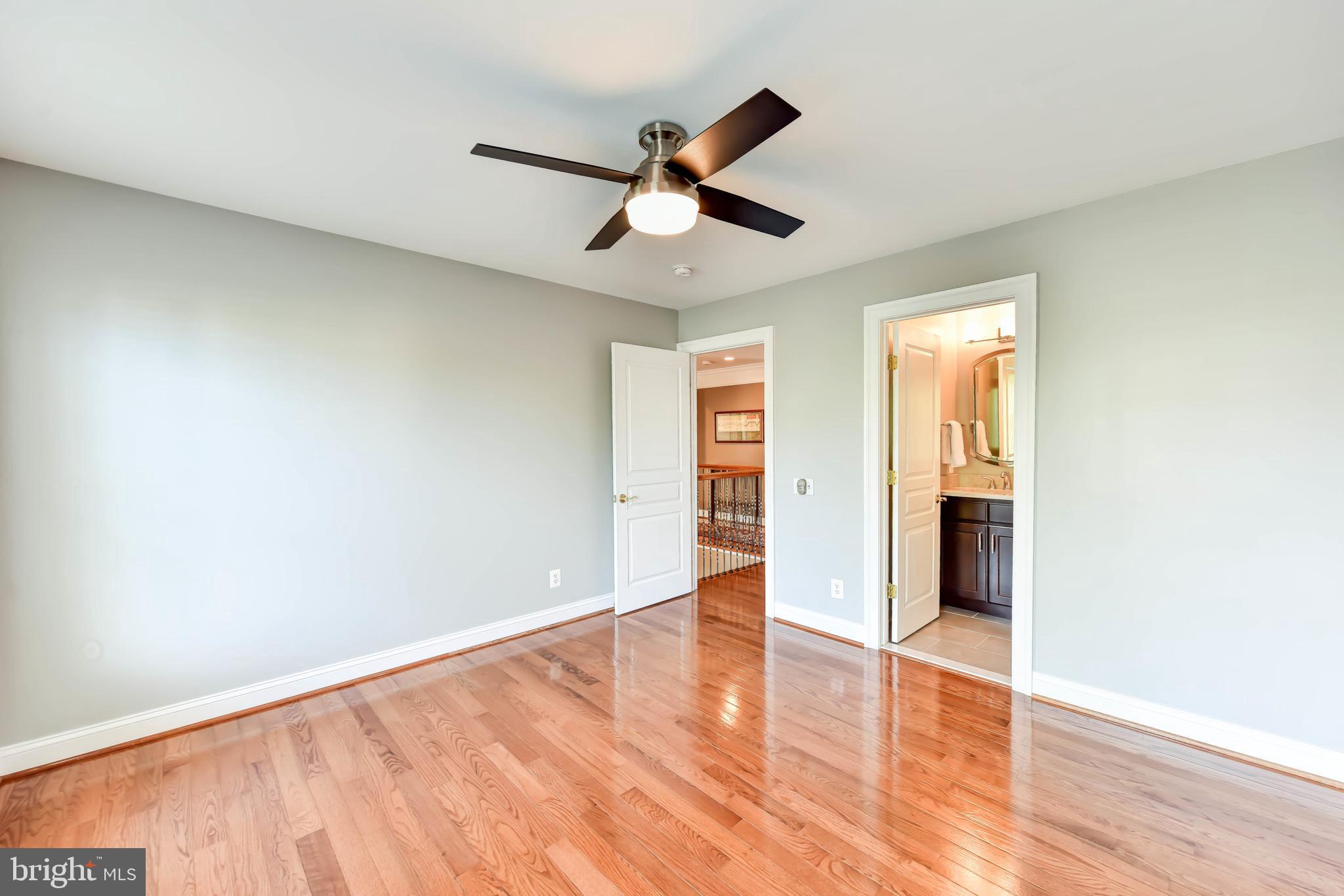8244 Native Violet Drive Lorton, VA 22079 - Photo 45 of 68 an empty room with wooden floor ceiling fan and windows