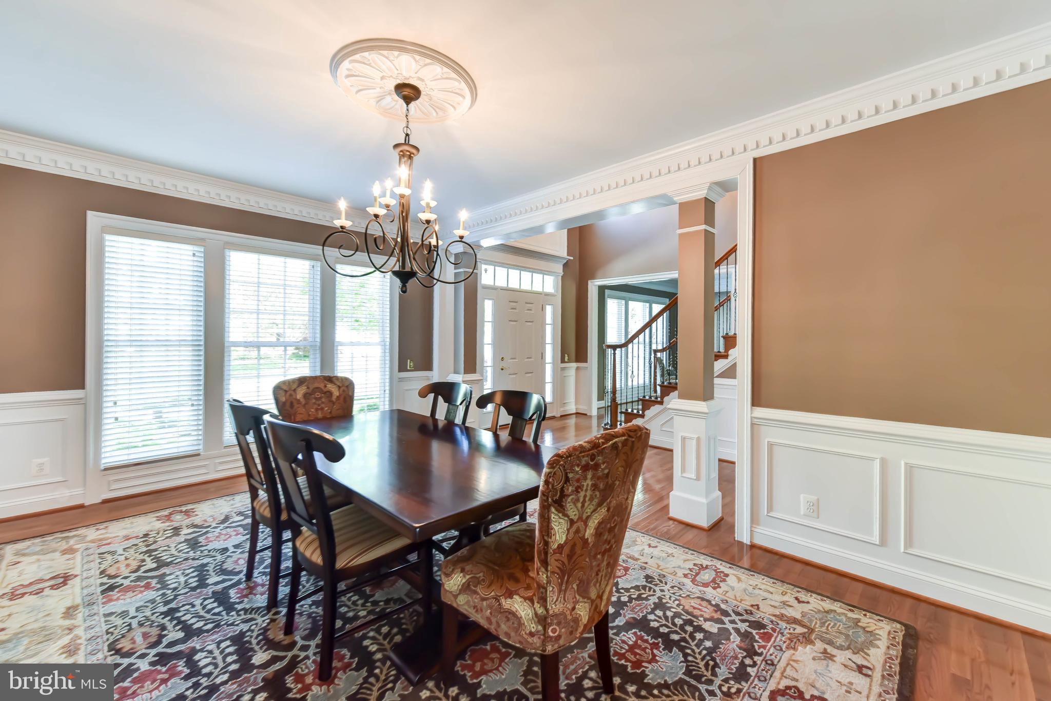 8244 Native Violet Drive Lorton, VA 22079 - Photo 6 of 68 a view of a dining room with furniture wooden floor and chandelier