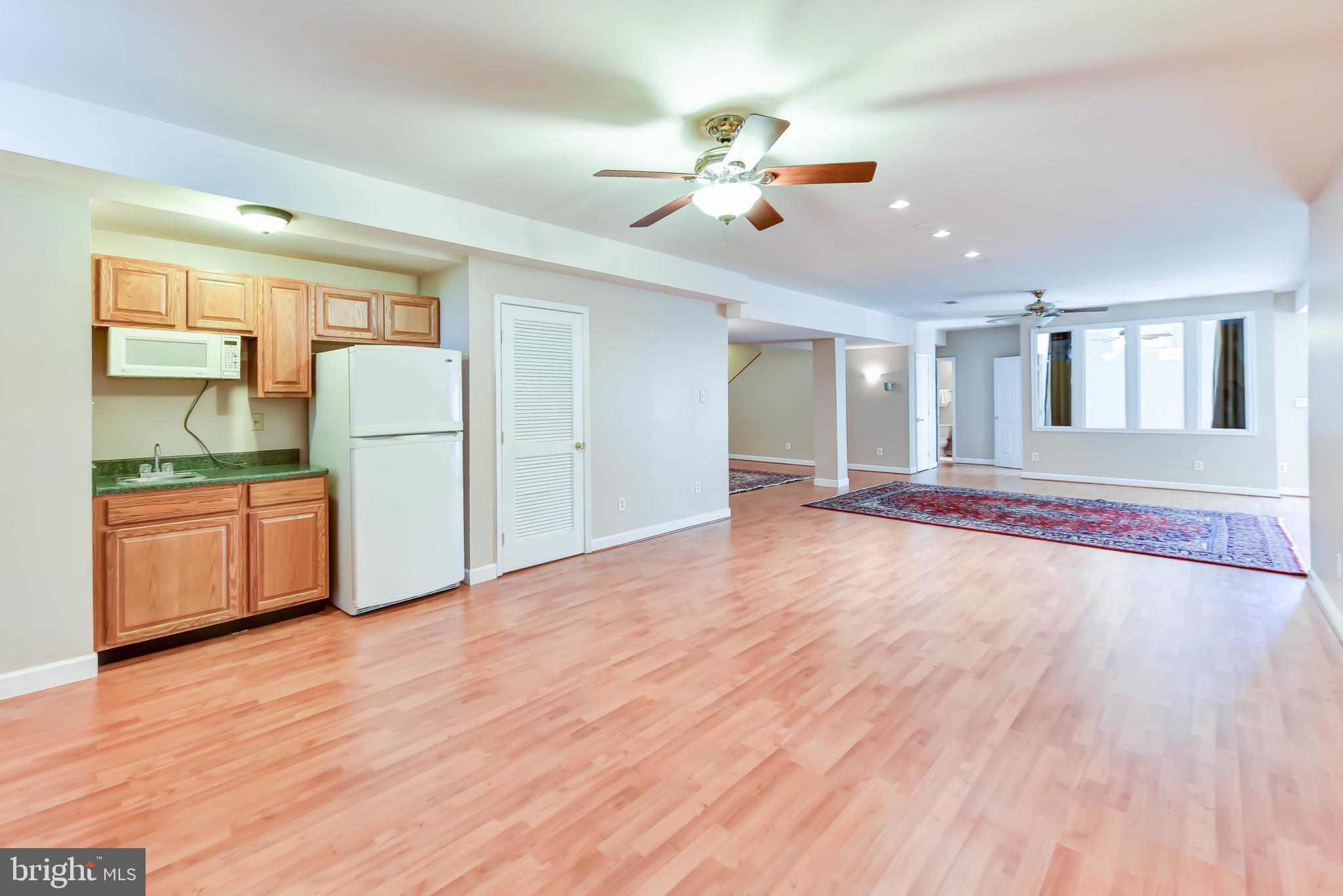 8244 Native Violet Drive Lorton, VA 22079 - Photo 54 of 68 a view of a room with wooden floor and a kitchen