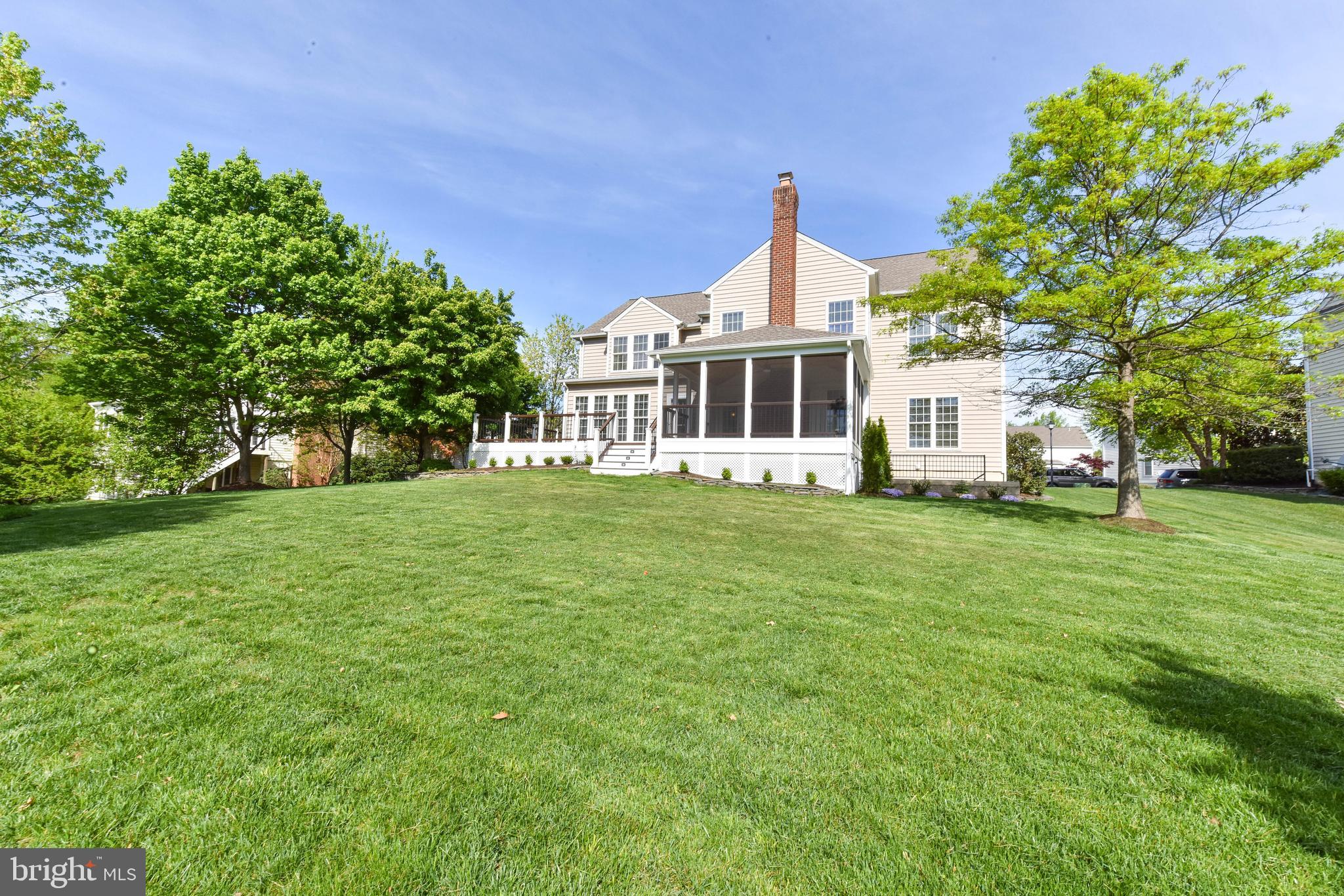 8244 Native Violet Drive Lorton, VA 22079 - Photo 62 of 68 a front view of a house with a garden and trees