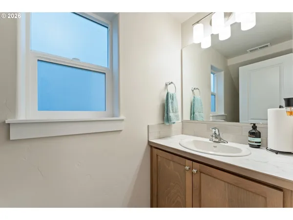 a bathroom with a sink vanity and a mirror