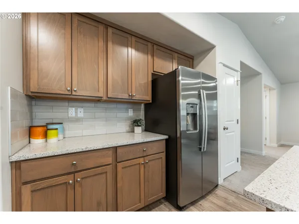 a kitchen with a refrigerator and cabinets