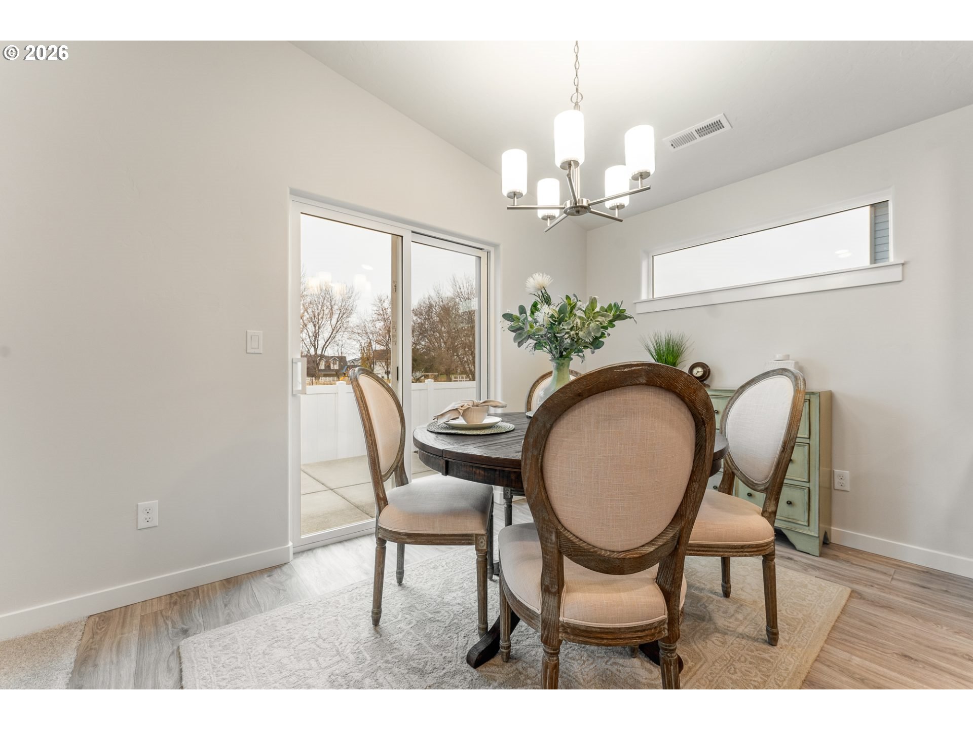 5177 Holly Street Springfield, OR 97478 - Photo 6 of 14 a dining room with furniture a chandelier and wooden floor