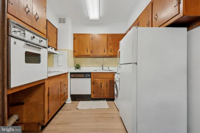 a kitchen with stainless steel appliances a refrigerator and a stove