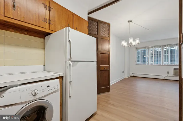 a view of a kitchen with refrigerator and cabinets