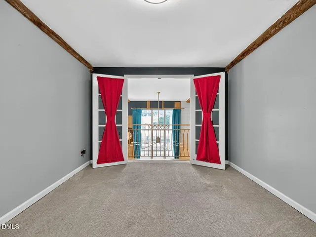 a view of a livingroom with wooden floor and a flat screen tv