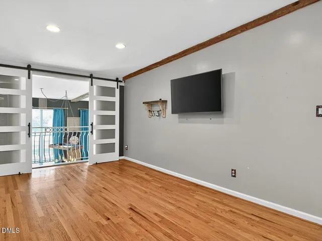 a large room with kitchen view and a fireplace