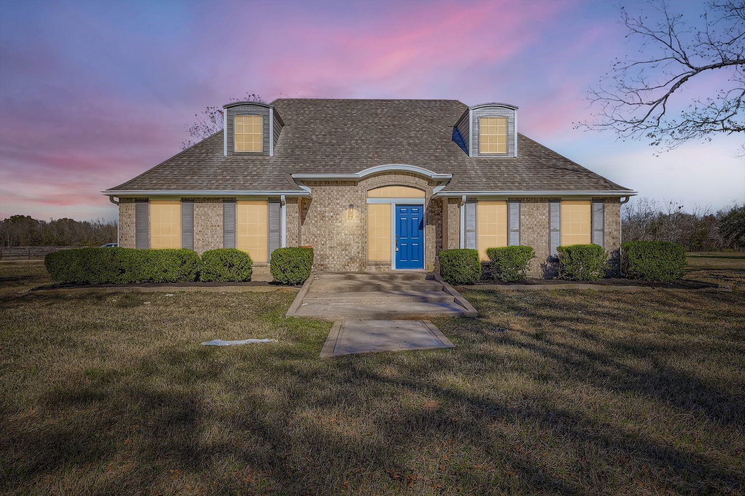 a front view of a house with a yard
