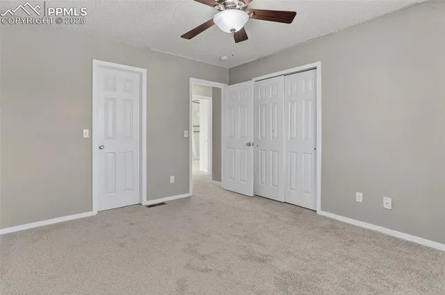 a bathroom with a granite countertop sink a toilet and a mirror