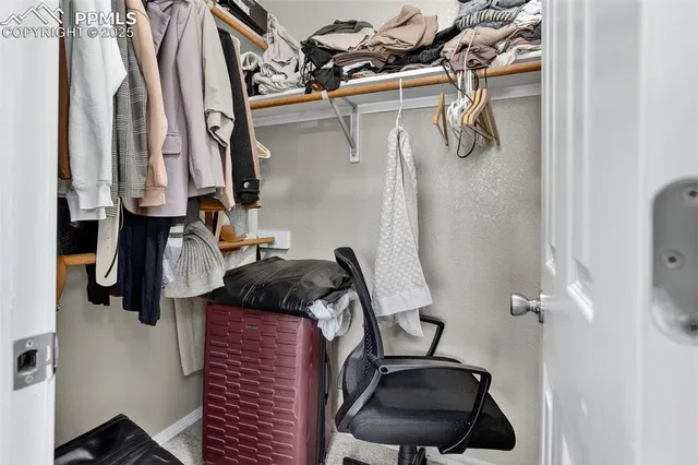 an empty room with closet and windows